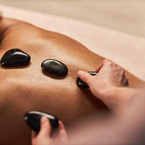 Prikaz masaže toplim kamenjem u Alex therapy salonu za masažu u Novom Sadu